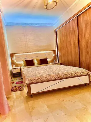 a bedroom with a large bed in a room at Lilia apartment marrakech in Marrakech