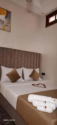 a bedroom with a bed with towels on it at Red Studio Marrakech in Marrakech