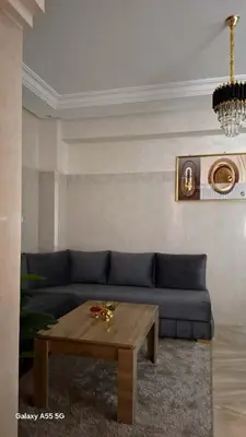 a living room with a blue couch and a coffee table at Red Studio Marrakech in Marrakech