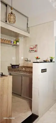 a white kitchen with a counter and a refrigerator at Red Studio Marrakech in Marrakech