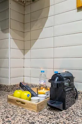 a kitchen counter with a grill and apples on a counter top at Emeraude - Confort et parking privé in Marrakech