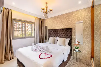 a bedroom with a bed with a heart decoration on it at Emeraude - Confort et parking privé in Marrakech