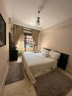 a bedroom with a bed and a large window at Caprice Palace in Marrakech