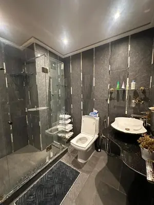 a bathroom with a shower and a toilet and a sink at Caprice Palace in Marrakech