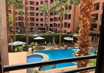a view of a pool from a balcony of a hotel at Caprice Palace in Marrakech