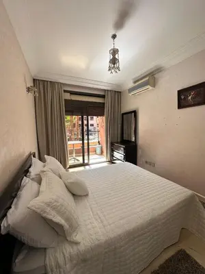 a bedroom with a white bed and a window at Caprice Palace in Marrakech