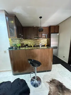 a kitchen with a bar with a stool in it at Caprice Palace in Marrakech