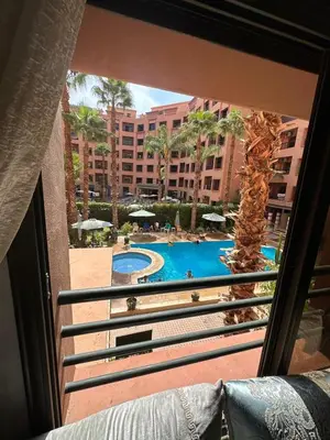 a view of a swimming pool from a balcony at Caprice Palace in Marrakech