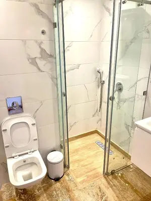 a bathroom with a toilet and a glass shower at Gueliz Harmony in Marrakech