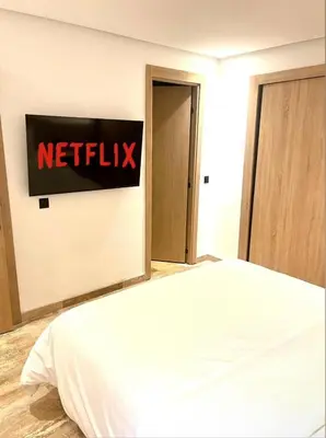 a bedroom with a netflix sign on the wall at Gueliz Harmony in Marrakech