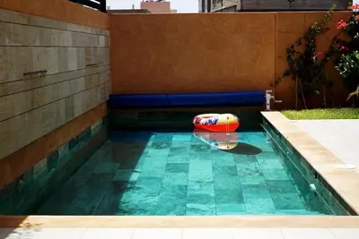 a pool with a inflatable ball in a backyard at Villa Lily in Tameslouht