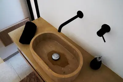 a bathroom with a wooden sink with two black lamps at Villa Lily in Tameslouht