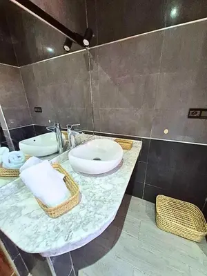 a bathroom with two sinks and a mirror at Villa Amroth in Marrakech