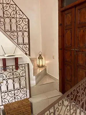 a set of stairs with a door and a lamp at Riad LK25 in Marrakech