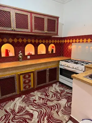 a kitchen with a rug on the floor at Riad LK25 in Marrakech
