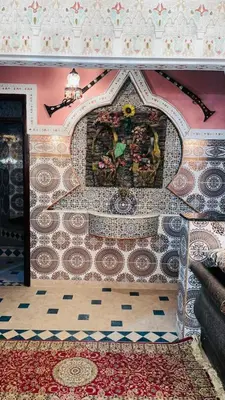 a room with a tile wall with a mural on it at Appartement in Marrakech