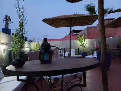 a table with a vase sitting on top of it at Breeze home in Marrakech