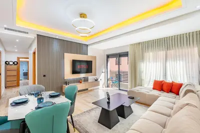 a living room with a couch and a table at Atlas Light Heart of Gueliz & Parking in Marrakech