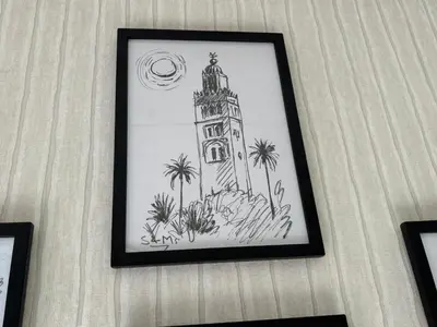a drawing of a clock tower on a wall at Appartement Original et unique en plein hivernage pour familles in Marrakech