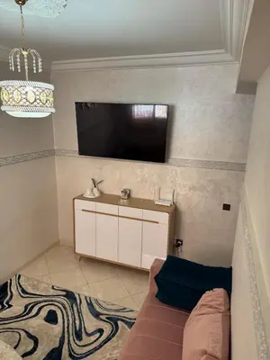a living room with a couch and a flat screen tv at My Marrakesh - G Floor in Marrakech