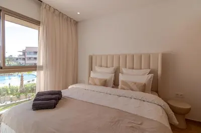 a bedroom with a large bed with a large window at Marrakech prestigia in Marrakech