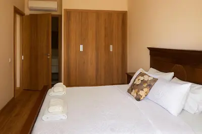 a bedroom with a large bed with two slippers on it at Ground floor 2 elegant bedrooms with direct pool access in Marrakech