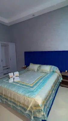 a blue bedroom with a bed with two pillows at Villa Elbidaoui in Marrakech