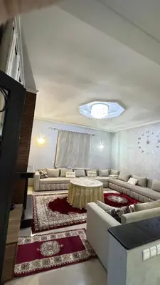 a living room with couches and a table at Villa Elbidaoui in Marrakech