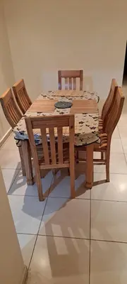 a wooden table with four chairs and a table with at Menara Amandier in Marrakech