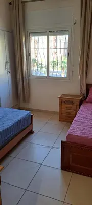 a bedroom with two beds and a window at Menara Amandier in Marrakech