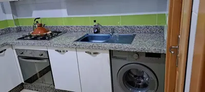 a kitchen with a sink and a washing machine at Menara Amandier in Marrakech