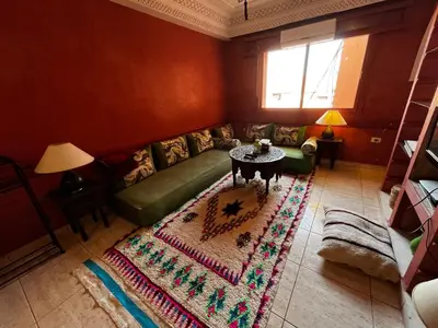 a living room with a green couch and a table at Dreams in Marrakech in Marrakech