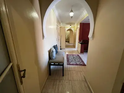 a hallway with a chair and an arch way at Dreams in Marrakech in Marrakech