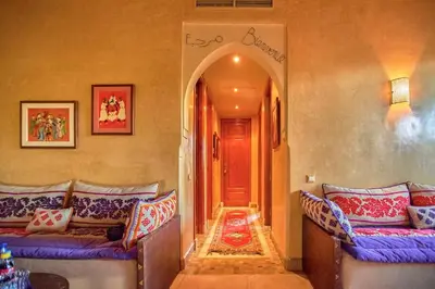 a living room with two couches and an archway at Condo in the Heart of the Palmeraie, Pools in Marrakech