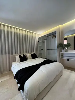 a large bedroom with a large white bed in it at Atlas-Si Cosy Appart Carré Eden in Marrakech