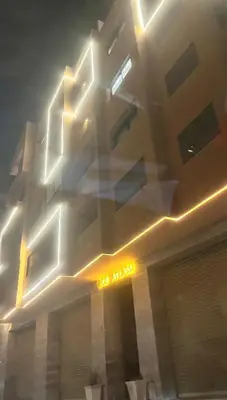 a building with lights on the side of it at Atlas-Si Cosy Appart Carré Eden in Marrakech