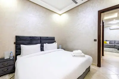 a bedroom with a large white bed and a mirror at Comfort and Simplicity in Marrakech in Marrakech