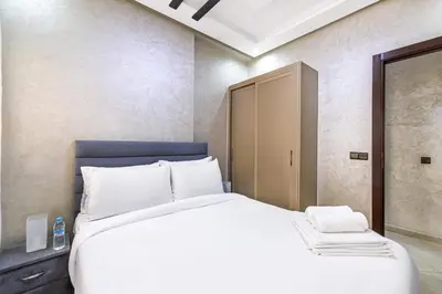 a bedroom with a large white bed and a closet at Comfort and Simplicity in Marrakech in Marrakech