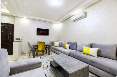 a living room with a couch and a table at Comfort and Simplicity in Marrakech in Marrakech