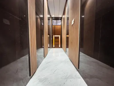 a hallway with wooden doors in a building at Luxury Apt near Majorelle & City Center in Marrakech