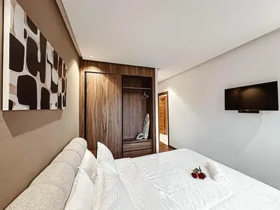 a bedroom with a bed and a television on a wall at Luxury Apt near Majorelle & City Center in Marrakech