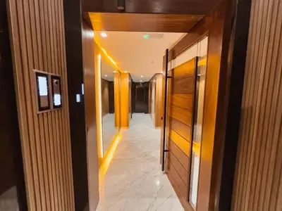 a hallway in a building with yellow lights on the ceilings at Luxury Apt near Majorelle & City Center in Marrakech