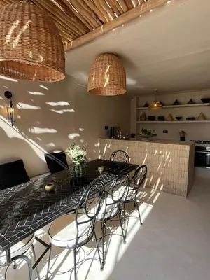 a dining room with a table and chairs at Riad Muvira in Marrakech