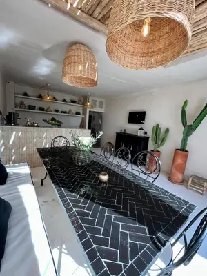 a dining room with a glass table with chairs at Riad Muvira in Marrakech