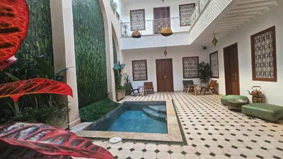 a courtyard with a swimming pool in a house at Riad Jô & Spa in Marrakech