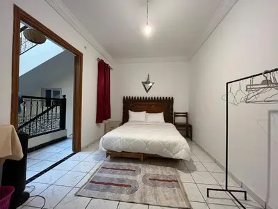 a bedroom with a bed and a balcony at Riad Flouris in marrakech in Marrakech