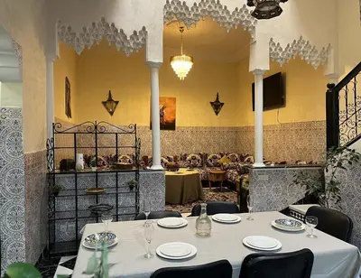 a dining room with a table and chairs at Riad Flouris in marrakech in Marrakech