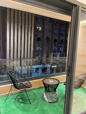 two chairs sitting in front of a window at Éros in Marrakech