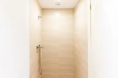 a shower with a wooden wall at splendid Villa King palace in Marrakech
