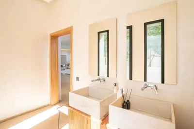 a bathroom with a sink and two mirrors at splendid Villa King palace in Marrakech